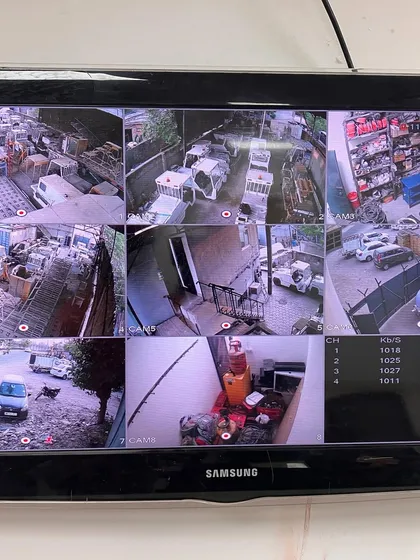A nine-camera feed monitoring a scrap yard or industrial depot. This is essential for asset protection and monitoring vehicle movement.