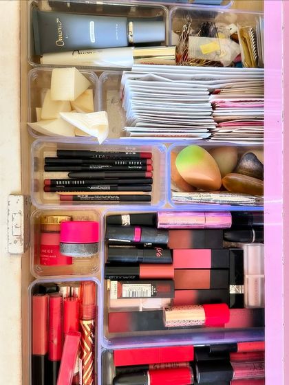 A beautifully organized makeup drawer. We used clear trays to create compartments for lipsticks, pencils, and foundations, making everything easy to find.