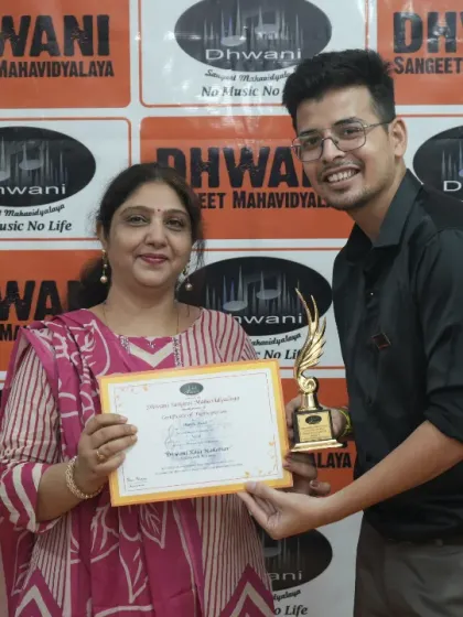 A teacher presents an award to an adult student.