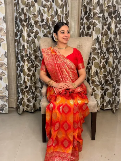 A full-length seated portrait that captures the complete traditional ensemble. The makeup, hair, and draping all work in harmony to create a look of pure elegance.