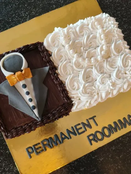 A fun bachelorette cake for "Permanent Roommates," designed as a groom's tuxedo and a bride's dress.