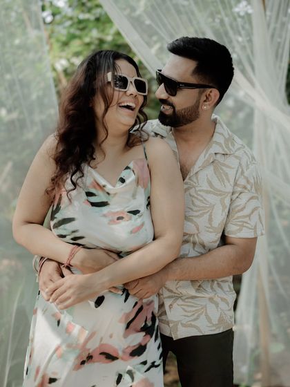 An embrace filled with laughter and happiness. This photo, with its soft lighting and natural setting, perfectly captures a lighthearted and loving moment.