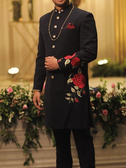 The placement of the embroidery is designed to flow naturally with the garment. Here, the floral pattern climbs the sleeve and side, creating a visually stunning effect.