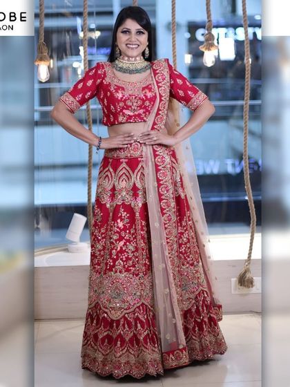This classic red bridal lehenga is a dream come true. With its rich embroidery and timeless design, it's the perfect outfit to start your forever.
