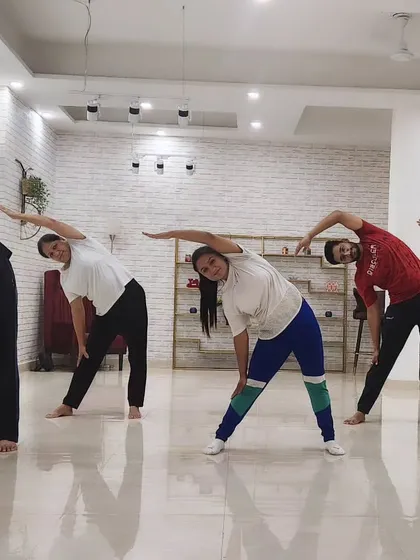 This is from one of my group yoga classes at The Marun Dance Studio in Dwarka. I'm guiding my students through a side-stretching sequence to improve flexibility and release tension.