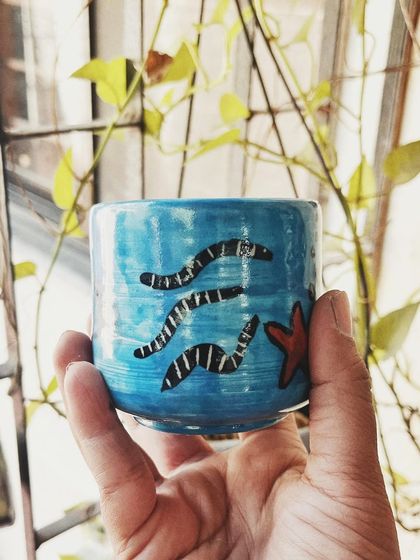 This student started with a one-time workshop and came back to begin his pottery journey. His pieces, like the quirky radio and the massive planter, are full of fun and character.