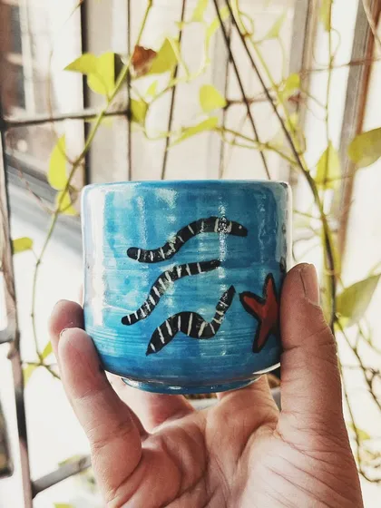 This student started with a one-time workshop and came back to begin his pottery journey. His pieces, like the quirky radio and the massive planter, are full of fun and character.