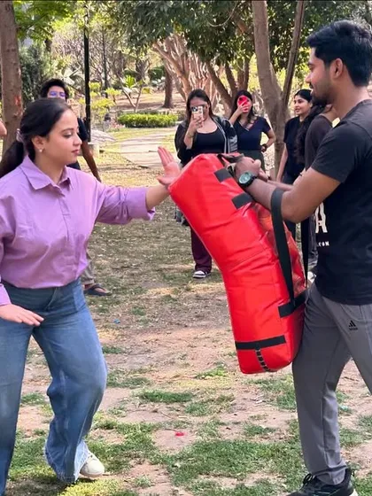 A student practices a palm-heel strike during an outdoor workshop with Girl Up Femina. Learning to generate power is a key part of building confidence.