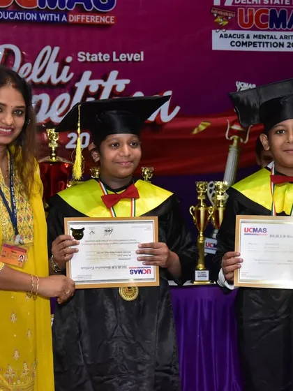 Another photo of our students proudly displaying their certificates and medals at the 17th Delhi State Level Competition awards ceremony, accompanied by their supportive instructor.