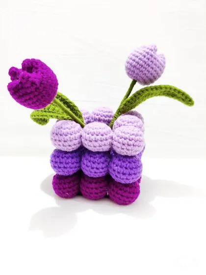 Another angle of the crochet tulip pot, highlighting the two shades of purple tulips.