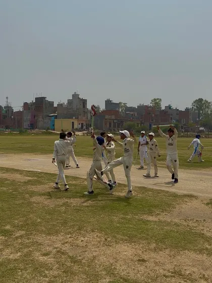 The winning moment. Players celebrating after winning the final of the Summer Cricket Cup.