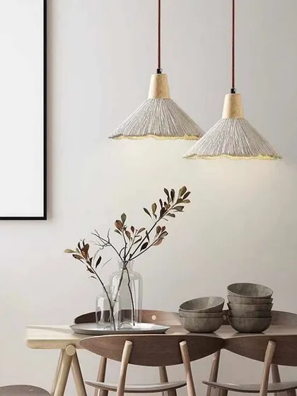 A pendant light with a textured, woven shade, perfect for adding a rustic or bohemian touch to a dining space.