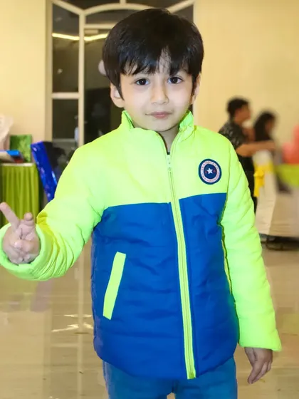 A young guest strikes a pose for the camera. I make sure to photograph the little friends who make the party special.