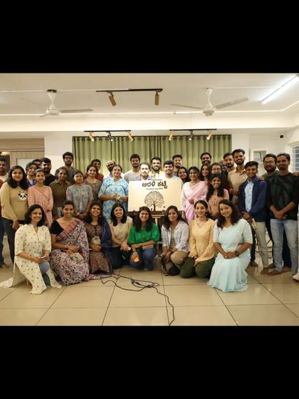 The entire "Arali Katte" community comes together for a celebratory group photo.