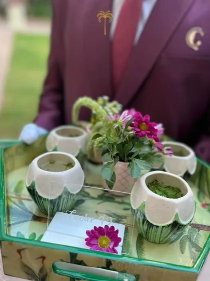 A tray of refreshing green coolers served in unique floral-base ceramic cups. Our distinctive serveware is part of what makes a Chetak event special.