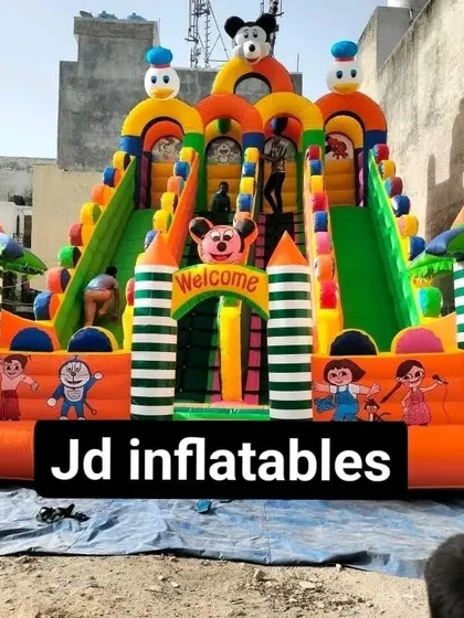 A large 4-slider bouncy castle being set up, showing its scale. This model is perfect for large community events or commercial amusement areas.