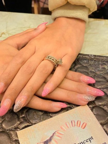 A beautiful pink and silver glitter ombre on long, stiletto-shaped nails. This design is perfect for a glamorous and eye-catching look.