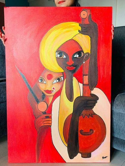 A client holding the large, vibrant musician painting. Creating custom wall art that brings so much color and character to a home is incredibly fulfilling.