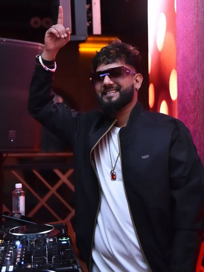 A happy and confident pose, pointing to the sky. The only way is up.