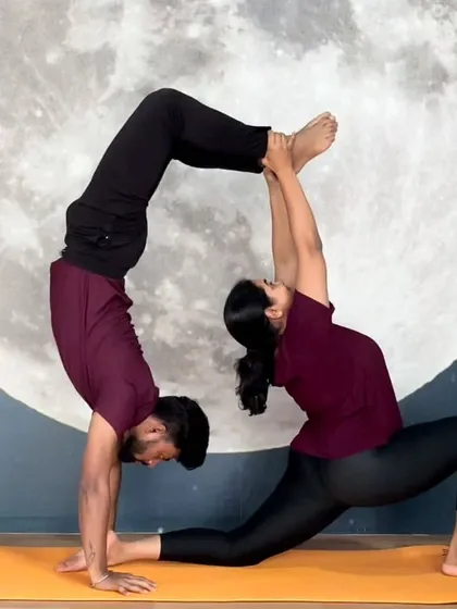 Yoga can also be a practice of connection and trust. This beautiful partner yoga pose combines the strength of a forearm stand with the flexibility of a supported lunge, creating a stunning display of balance and teamwork.