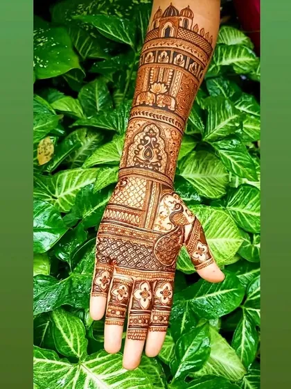 A beautiful bridal design against a natural green backdrop, highlighting the intricate palace and peacock motifs that are central to the artwork.