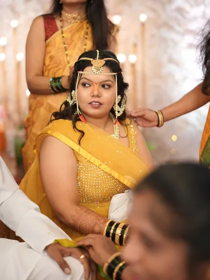 A clear shot of the bride during her Haldi ceremony, her makeup fresh and simple to let her natural beauty shine.