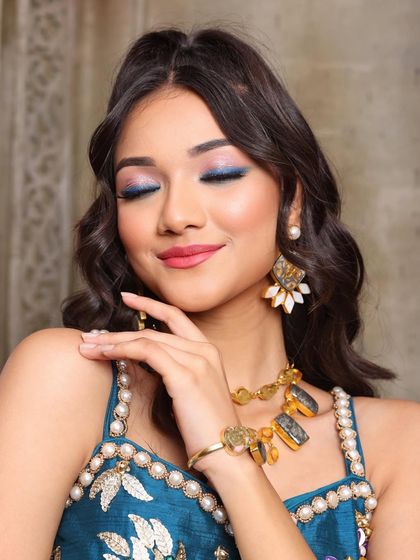 A close-up on the stunning blue eye makeup. We blended different shades to create a multi-dimensional look that is both artistic and wearable.