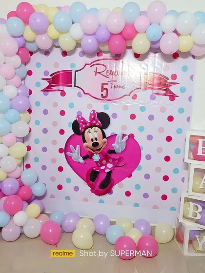 A cute Minnie Mouse themed birthday party for Reya's 5th birthday. The setup includes a character backdrop, a pastel balloon arch, and "BABY" blocks for a playful touch.