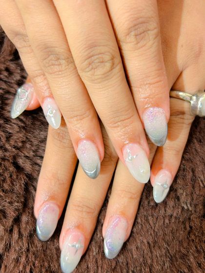 A frosty and delicate look with a silver and purple glitter ombre and tiny silver charm accents.