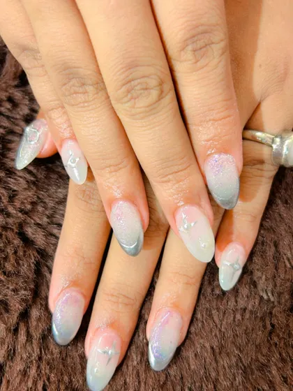 A frosty and delicate look with a silver and purple glitter ombre and tiny silver charm accents.
