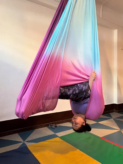 Look at that smile. This is what it feels like to trust the hammock and see the world from a new perspective. This supported inversion helps decompress the spine and feels absolutely wonderful.
