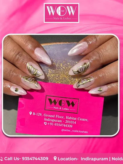 Let your nails become a piece of art. This design features elegant, hand-painted golden butterflies on a pearlescent base, showcasing the intricate and artistic capabilities of our talented nail technicians.