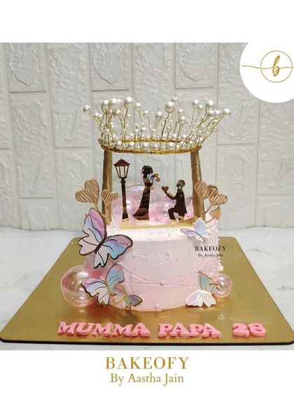 A beautiful anniversary cake with a proposal silhouette, crowned with pearls and surrounded by butterflies. This vanilla cake was designed to celebrate a long and happy journey of love.