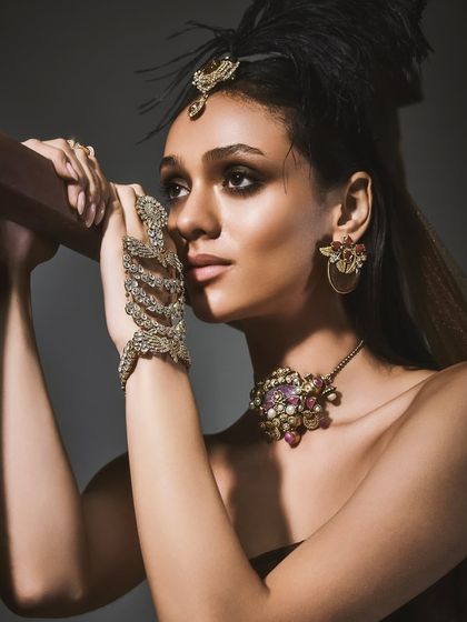 A detailed close-up of the "Regal Dusk" collection by Reasons Jewellery, showing the craftsmanship of the necklace, earrings, and hand bracelet.