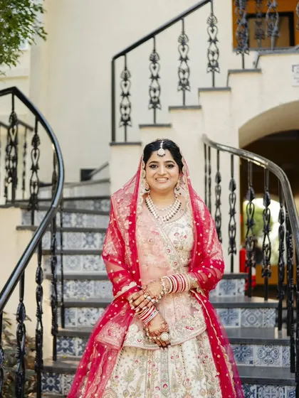 A series showcasing a beautiful sunset wedding look. The bride's makeup is soft and romantic, with a flawless base and defined eyes, perfectly complementing her stunning pastel lehenga for a picturesque Goa wedding.