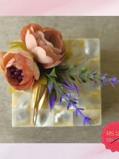 This mother-of-pearl box, decorated with delicate flowers, is part of my clearance sale. It's a beautiful and affordable option for a small jewelry box or a decorative piece.