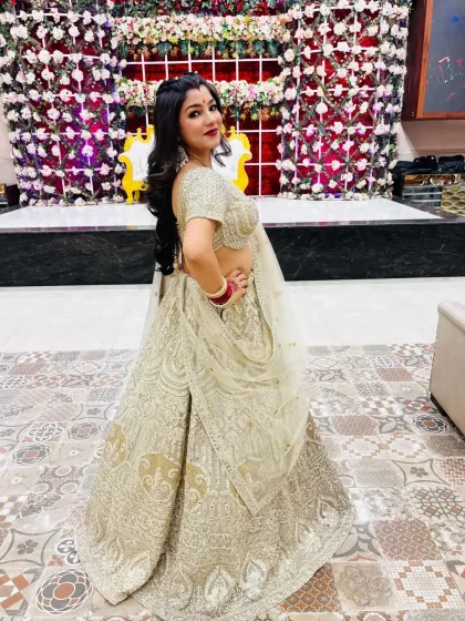 A series of photos of my happy client looking absolutely stunning in a heavily embroidered silver-grey lehenga at her reception. She owned the look completely!