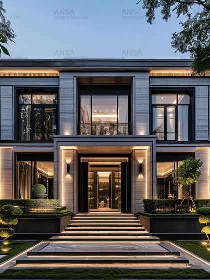 The entrance to a home sets the tone for everything inside. This grand entryway with its illuminated staircase and clean, modern lines creates an immediate impression of sophistication and style, welcoming you into a world of curated design.