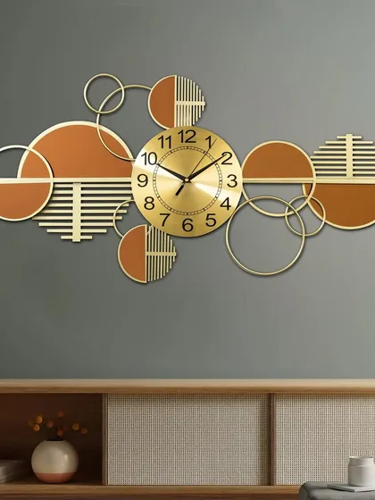 Time meets art in this handcrafted metal wall art clock. The horizontal design with abstract circles in gold and terracotta tones makes it a striking statement piece to hang above a console or sofa.