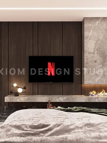 The TV wall in the same bedroom features a floating console with an integrated fireplace, set against a backdrop of dark wood paneling and marble.