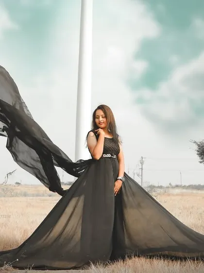 Make a bold statement with a black trail gown. This pre-wedding shot shows how the long, flying fabric can create powerful and dramatic shapes against an open landscape, giving your photos a high-fashion feel.