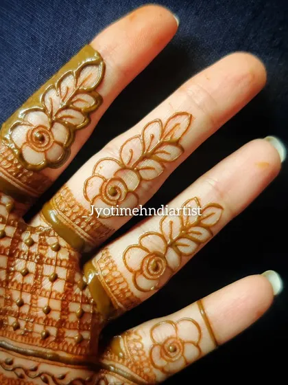 Detailed floral cutwork on the fingers. I teach how to create these intricate and delicate patterns.