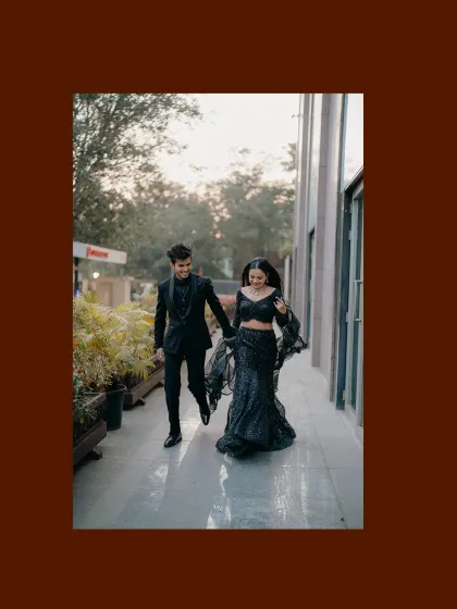 The couple walking hand-in-hand at their reception. The motion in the bride's dress and their happy stride capture the energy of the celebration.