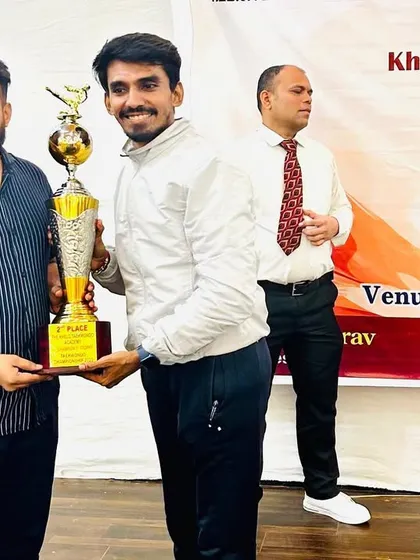Receiving the 2nd place team trophy at the 5th Champions Trophy 2023 on behalf of my hardworking team.