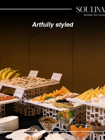 An artfully styled buffet featuring a beautiful spread of cheeses, crackers, and fruits. Our displays are designed to be as visually appealing as they are delicious.