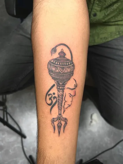 A tribute to Lord Hanuman, featuring his mace (gada), the Om symbol, and a subtle outline of his face. This design represents strength, devotion, and divine power.