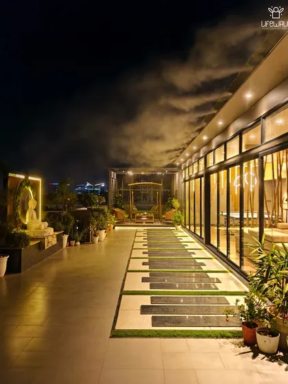 We don't just design terraces; we create experiences. This expansive rooftop features a unique piano key pathway, a serene Buddha installation for meditation, and a cozy swing set under a pergola, all overlooking the city lights.