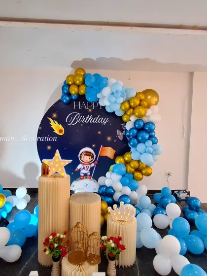 Another perspective of the space-themed setup, focusing on the arrangement of the pedestals and decorative elements like the star and crown props.