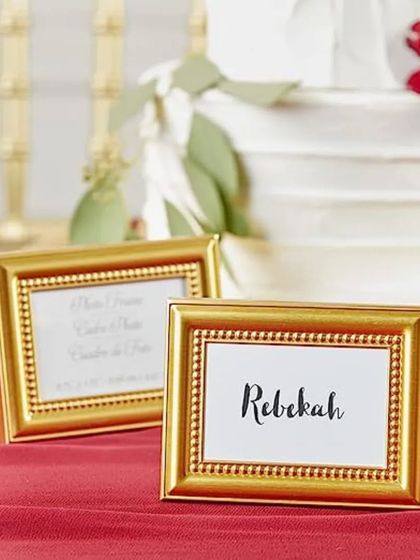 For a classic and sophisticated look, I offer these miniature gold photo frame place card holders. They beautifully frame each guest's name and can be taken home as a lovely party favor.