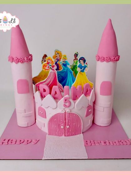 A fairytale castle cake for a 5th birthday. This pink castle is decorated with the Disney princesses, ready for a royal ball.